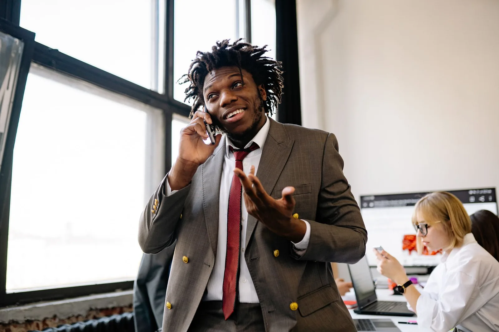 Salesperson on a call in an office — personalized B2B outreach research before the message is sent